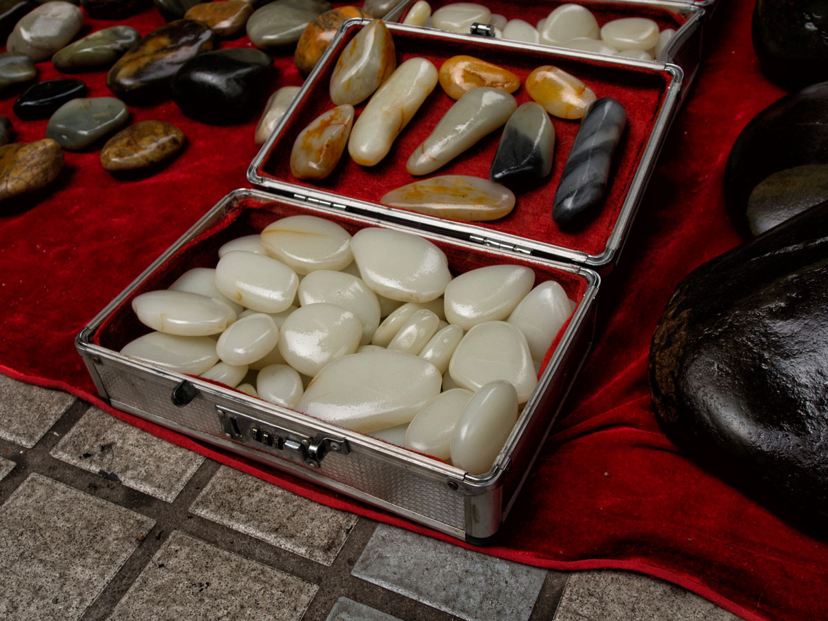 A suitcase of what appears to be Chinese nephrite in Guangzhou's Hualin Street jade market. Like many gem markets, caveat emptor is the norm as imitations abound. Lotus gemology on jade, nephrite, and imitations.