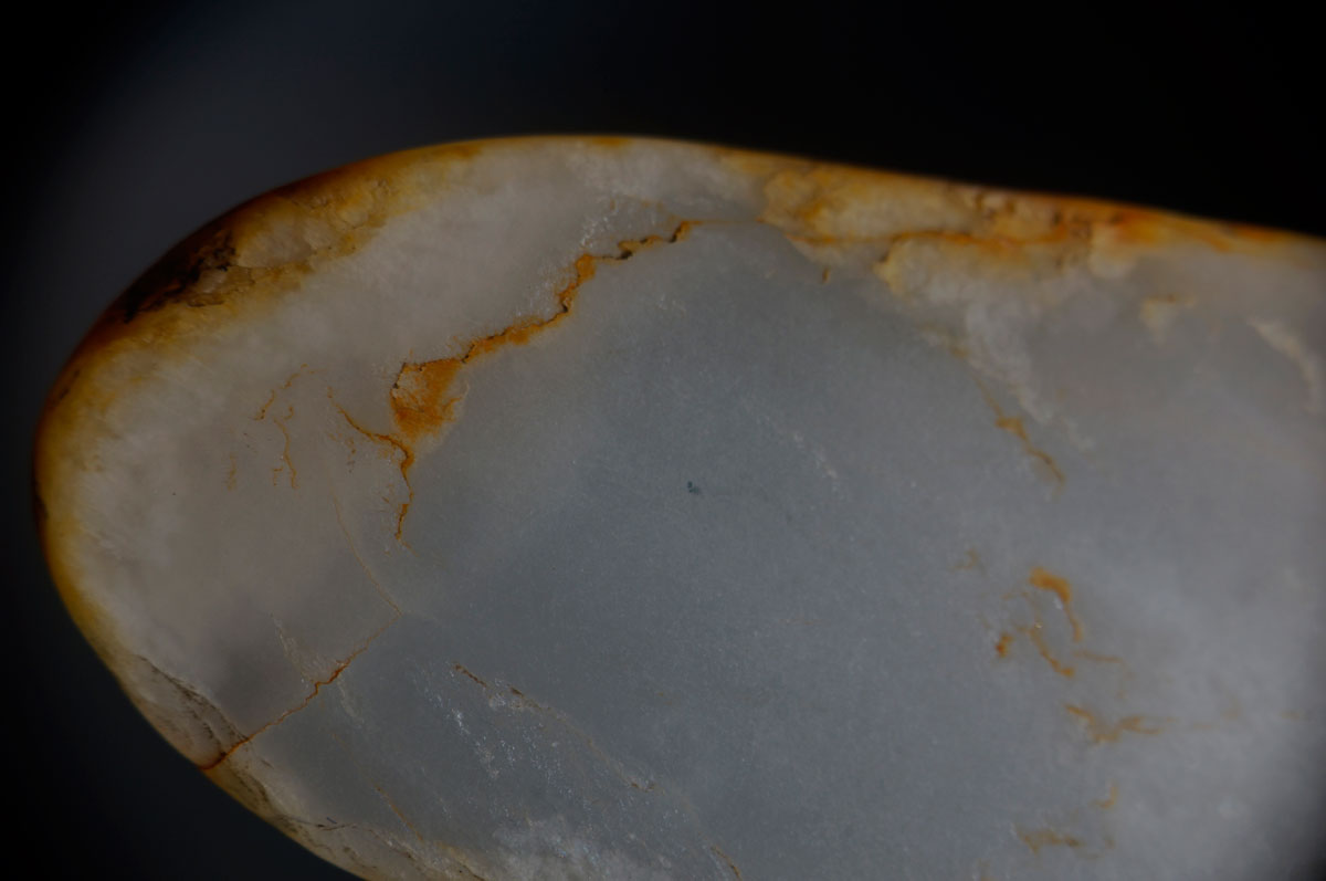 Chinese white nephrite with iron oxide stains purchased in Guangzhou's Hualin Street jade market. From Lotus Gemology.