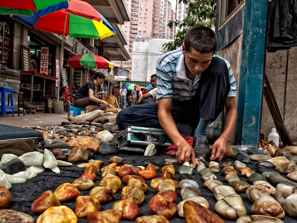 A Uyghur sells jade boulders Guangzhou, China's Hualin Street jade market. From Lotus Gemology.