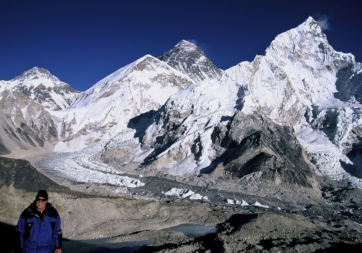 Kala Patar Richard Hughes at Kala Patar above Gorak Shep in Nepal's Khumbu District, with Mt. Everest (center; 8848 m; 29,028 ft) in the background (2003). The author visited Everest from the Nepalese side in 1977 and 2003, but always dreamed of seeing it from the north. The top of Everest (above the yellow band) is actually limestone containing tiny marine fossils. Lhotse (8,414 m; 27,605 ft), fourth highest mountain in the world, dominates the scene to the right of Everest. Photo: Olivier Galibert