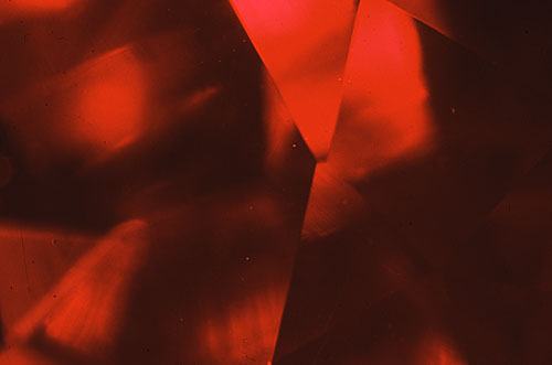Figure 3. Using darkfield illumination this Kashan flux-grown synthetic ruby looks virtually flawless. Magnified 15×. Photomicrograph © John I. Koivula, microWorld of Gems.