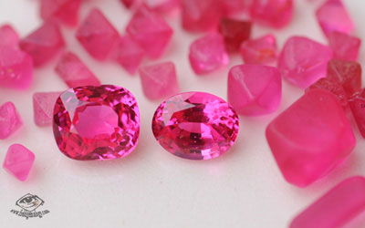 Hot pink spinels in rough and cut form from Namya, Burma.