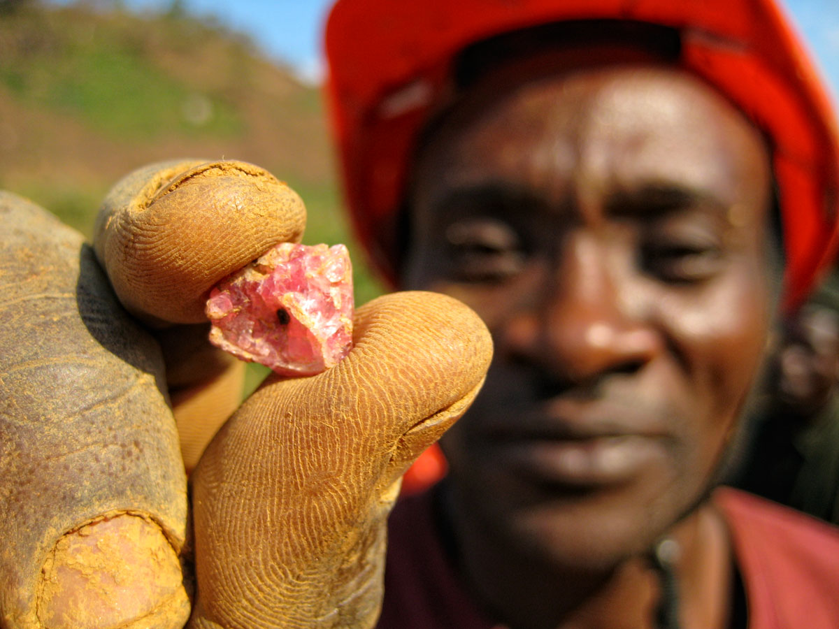 A miner at Ipanko holds a fragment of spinel.