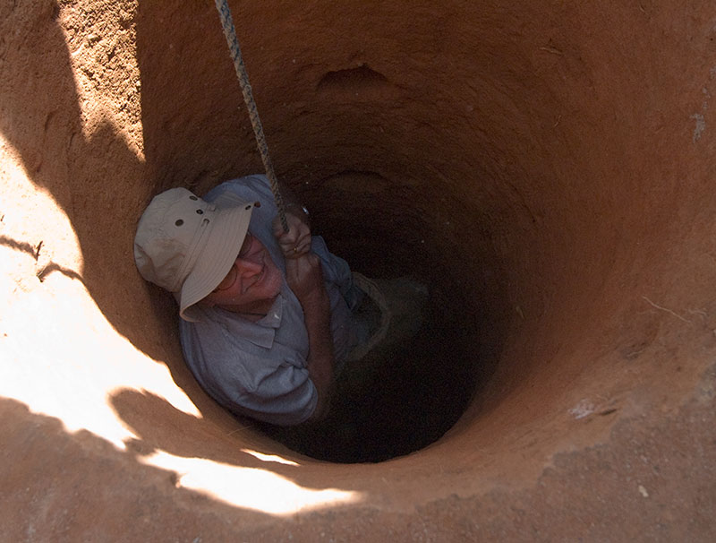 Richard Hughes descending into a gem pit in Madagascar. An album of photos such as this can help jewelers close sales because of the aura of expertise they establish