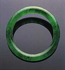 Figure 26. Believed to date back at least four millennia in China, the jade bangle is both one of the oldest and one of the most important pieces of jewelry in the Chinese culture. This superb jadeite bangle sold for US$2,576,600 at the Christie's Hong Kong November 1999 auction. The interior diameter is 49.50 mm; the jadeite is 8.36 mm thick. Photo courtesy of and © Christie's Hong Kong and Tino Hammid.