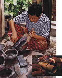 Figure 18. In Mandalay, cutters still use a board coated with a mixture of carborundum (of various grits) and hard wax to shape cabochons (photo by Mark Smith). They then polish jadeite on bamboo lathes, often without any abrasive (inset photo © 2000 Fred Ward).