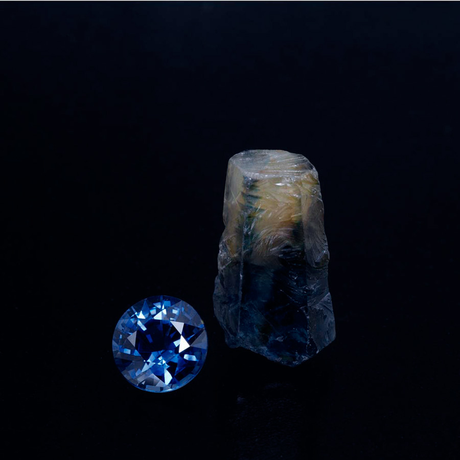 This 2.14-ct cut stone is an example of the finest production from Huay Xai. It sits next to an 11.99-ct parti-colored crystal, also from Huay Xai.