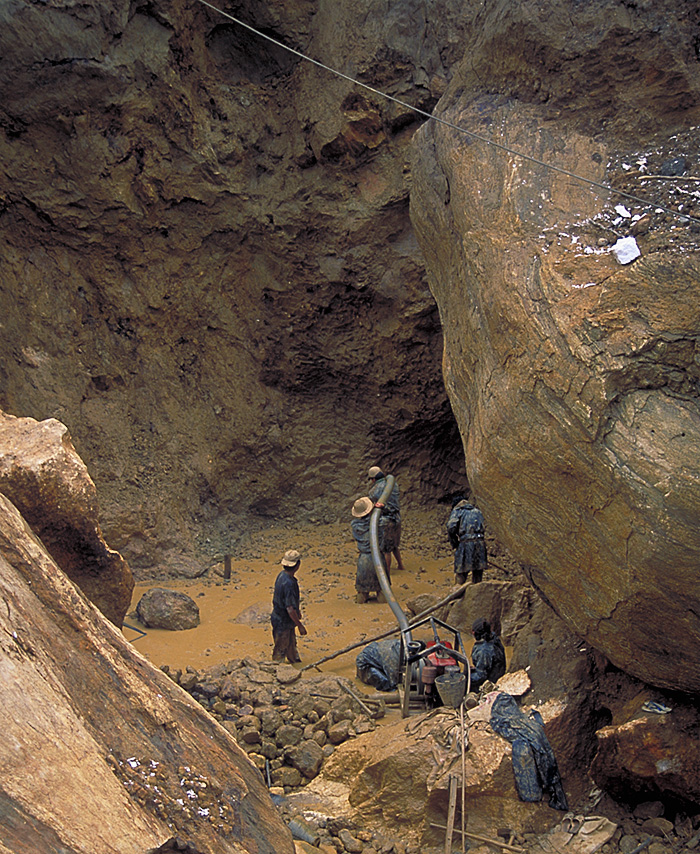 Miners at Inn Chauk, just north of Mogok, are dwarfed by massive limestone boulders as they hunt for pigeon's blood rubies.
