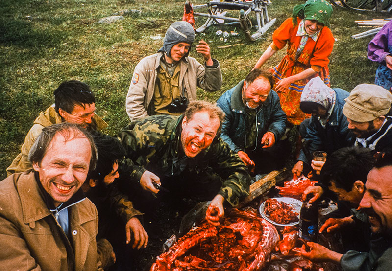 Nickolai Kouznetsov enjoying nyamnyukh (raw reindeer meat) and spirt (grain alcohol) with the Khant people near Kechpel (western Polar Urals).